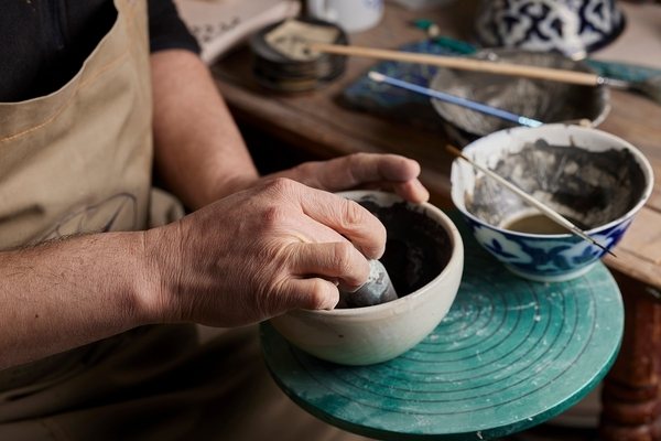 Hands glazing a bowl