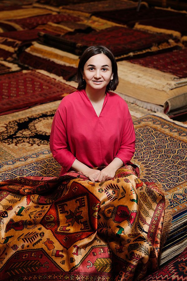 Sabina Burkhanova among silk carpets